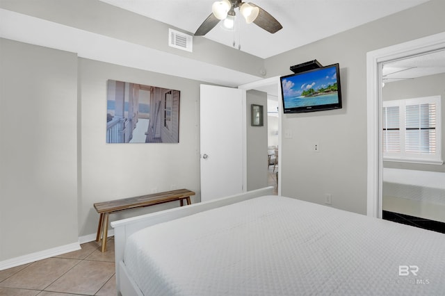 bedroom with light tile patterned flooring, baseboards, visible vents, and ceiling fan