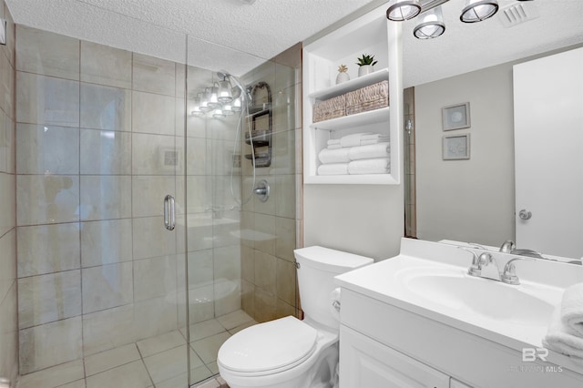bathroom featuring a shower stall, a textured ceiling, toilet, and vanity