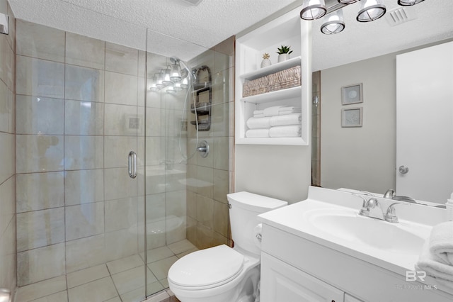 full bath with toilet, a stall shower, vanity, and a textured ceiling