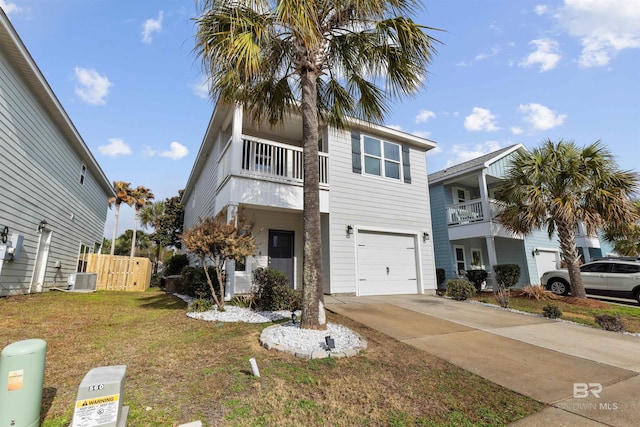 view of front of property featuring central AC unit, a garage, and a front yard