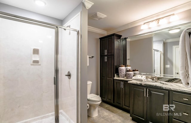 bathroom featuring tile floors, a shower with door, toilet, ornamental molding, and oversized vanity