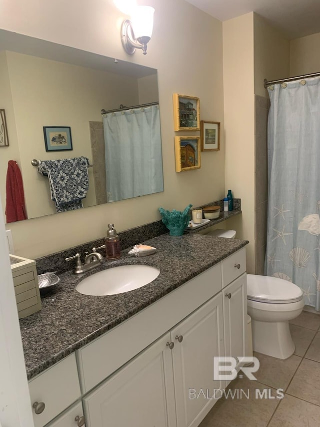 453 Dune Dr Unit 107, Gulf Shores, AL 36542 - full bath featuring tile patterned floors, vanity, toilet, and curtained shower