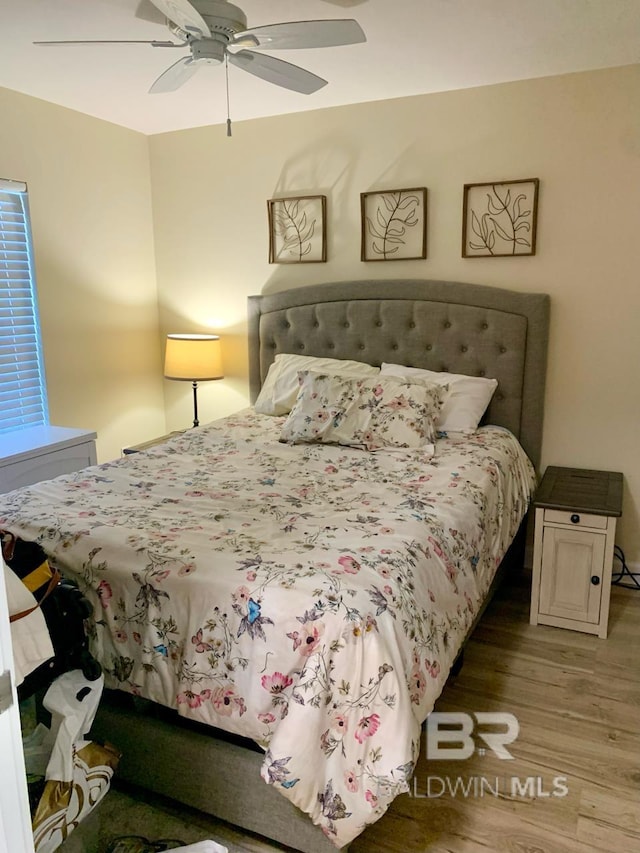 bedroom with wood-type flooring and ceiling fan