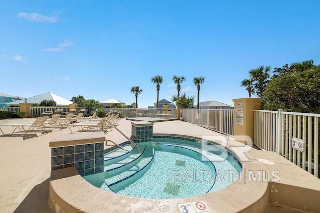 453 Dune Dr Unit 107, Gulf Shores, AL 36542 - view of pool with a hot tub, fence, and a patio