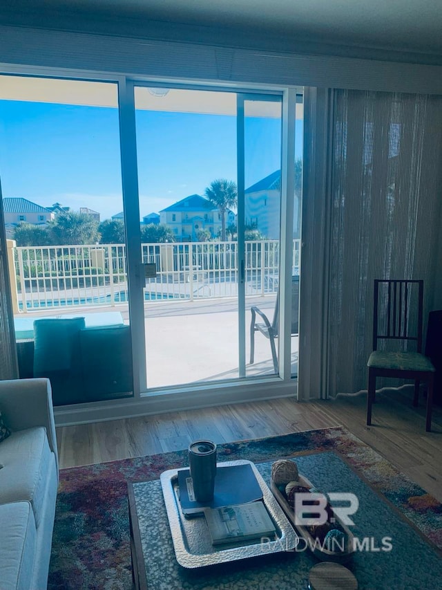 living room with a mountain view, hardwood / wood-style flooring, and plenty of natural light