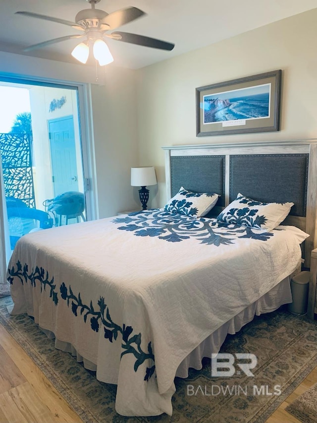 bedroom featuring access to outside, wood-type flooring, and ceiling fan