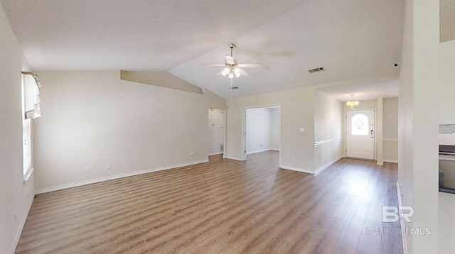 33580 Woodlands Dr, Lillian, AL 36549 - unfurnished living room with wood finished floors, ceiling fan, vaulted ceiling, and baseboards