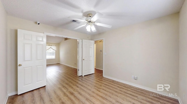 33580 Woodlands Dr, Lillian, AL 36549 - unfurnished bedroom with light wood-type flooring, baseboards, and ceiling fan