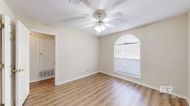 33580 Woodlands Dr, Lillian, AL 36549 - unfurnished room with light wood-style flooring, a textured ceiling, ceiling fan, and baseboards