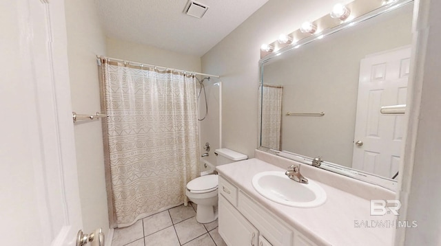 33580 Woodlands Dr, Lillian, AL 36549 - full bath featuring tile patterned floors, toilet, vanity, shower / tub combo with curtain, and a textured ceiling