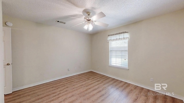 33580 Woodlands Dr, Lillian, AL 36549 - unfurnished room with wood finished floors, a textured ceiling, ceiling fan, and baseboards