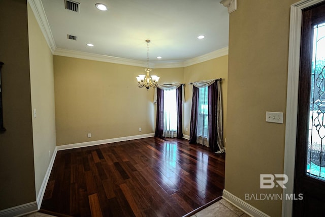 unfurnished room with a chandelier, crown molding, and dark hardwood / wood-style floors