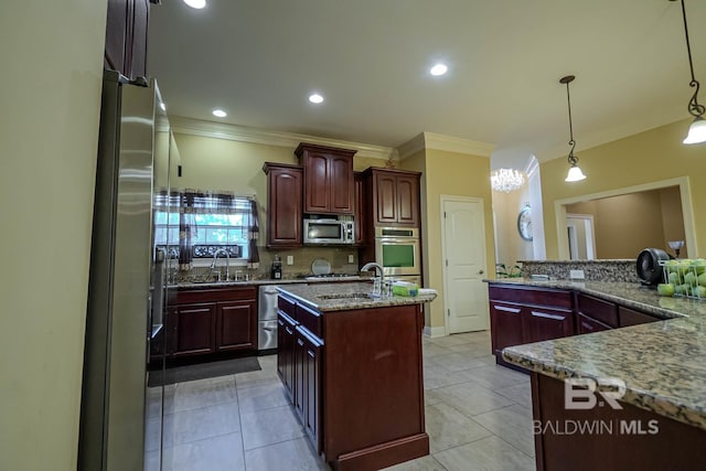 kitchen with appliances with stainless steel finishes, sink, a kitchen island, decorative light fixtures, and light stone countertops