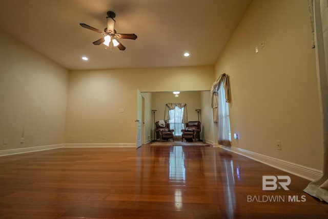 unfurnished living room with wood-type flooring and ceiling fan