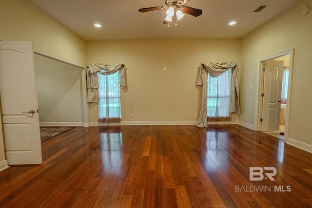 spare room featuring ceiling fan and dark wood-type flooring