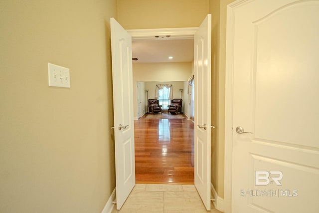 corridor with light tile patterned flooring