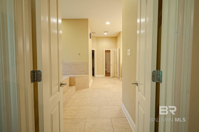 corridor with light tile patterned floors