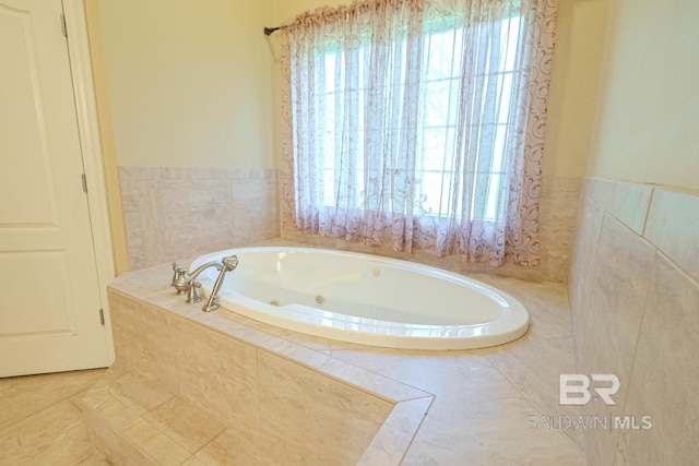 bathroom featuring a relaxing tiled tub and tile patterned floors