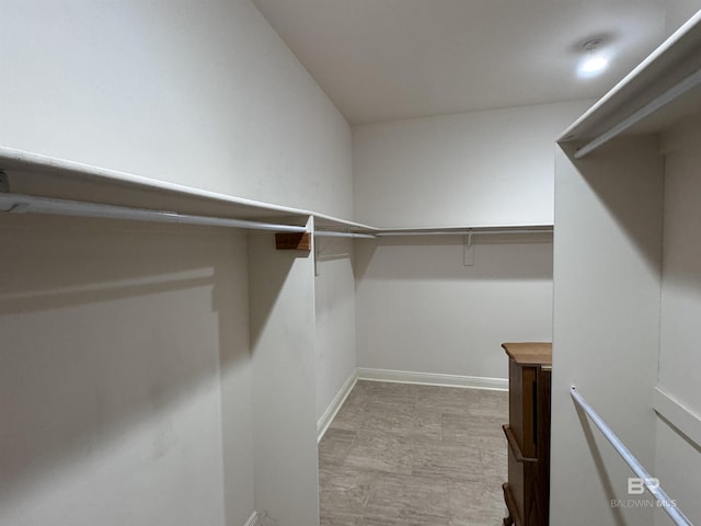 walk in closet with light wood-type flooring