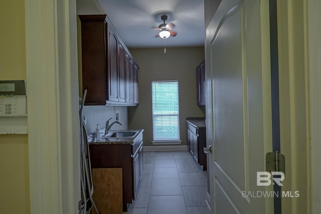 laundry area featuring cabinets, hookup for a washing machine, sink, ceiling fan, and light tile patterned floors