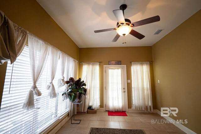 foyer with ceiling fan and light tile patterned floors