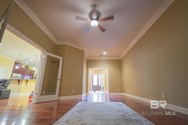 empty room with ceiling fan, ornamental molding, and hardwood / wood-style floors