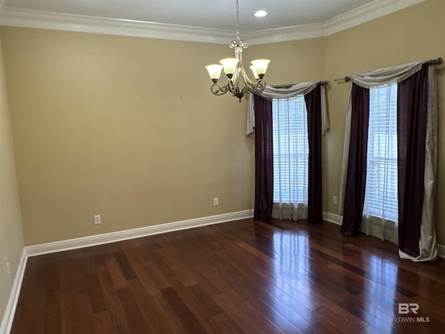 unfurnished room with a healthy amount of sunlight, an inviting chandelier, dark hardwood / wood-style flooring, and ornamental molding