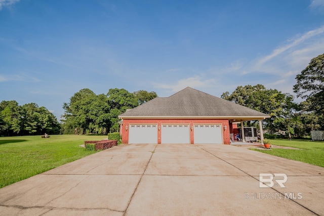 view of front of property with a garage and a front lawn