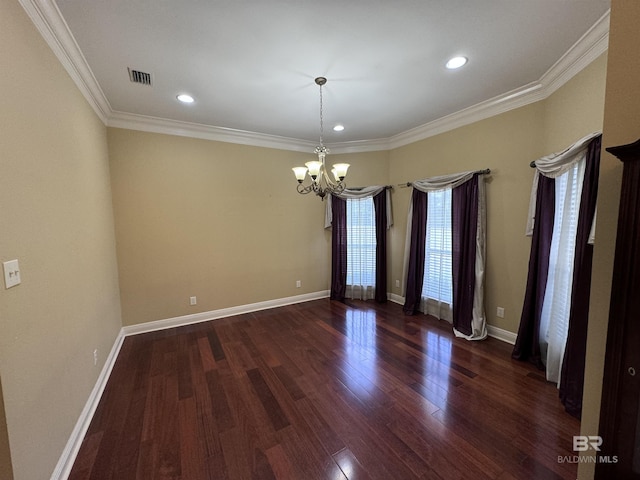 spare room with dark hardwood / wood-style flooring, ornamental molding, and an inviting chandelier