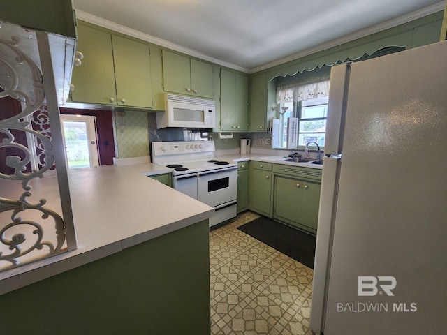 kitchen with green cabinets, a wealth of natural light, white appliances, and sink