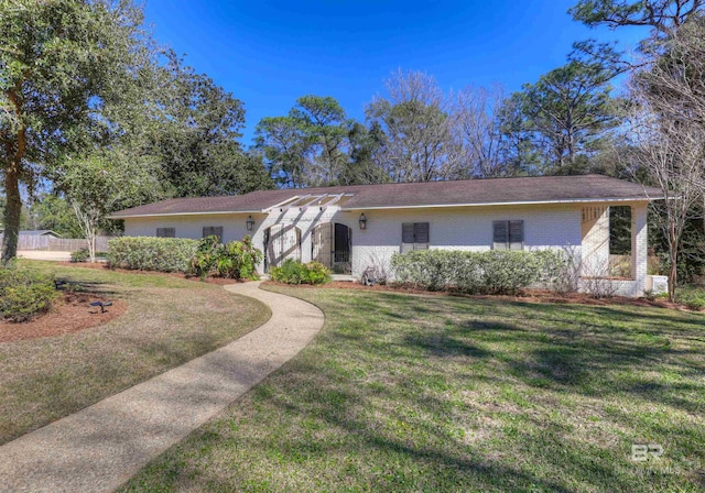 ranch-style home with a front lawn and brick siding