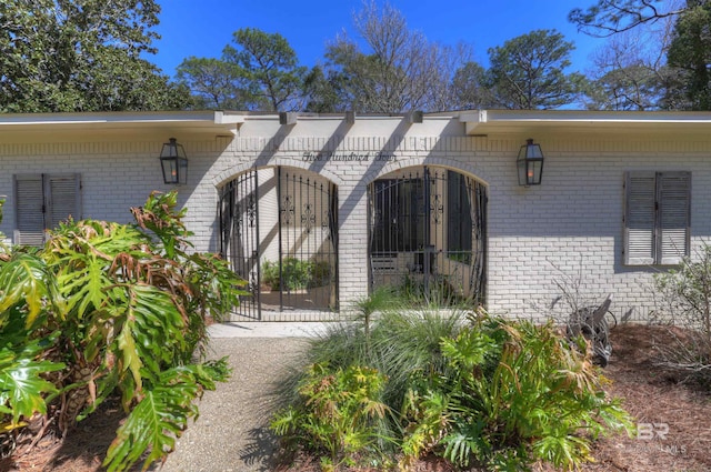 property entrance featuring brick siding