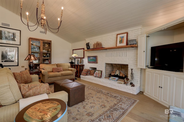 living area with light wood-style flooring, a fireplace, wood ceiling, vaulted ceiling, and an inviting chandelier