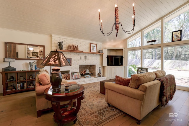 living room featuring wooden ceiling, hardwood / wood-style floors, an inviting chandelier, a fireplace, and high vaulted ceiling