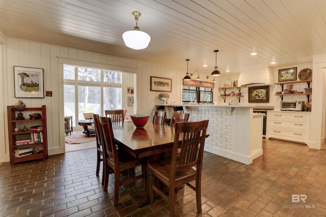 dining space with brick floor, recessed lighting, wooden ceiling, and a toaster