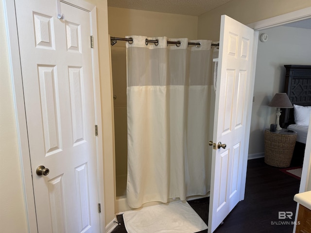 28712 Canal Rd, Orange Beach, AL 36561 - full bathroom featuring curtained shower, wood finished floors, and baseboards