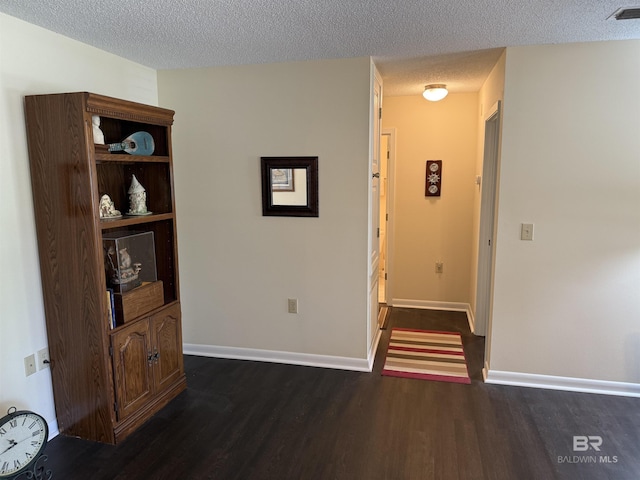 28712 Canal Rd, Orange Beach, AL 36561 - corridor with dark wood-style flooring, a textured ceiling, and baseboards