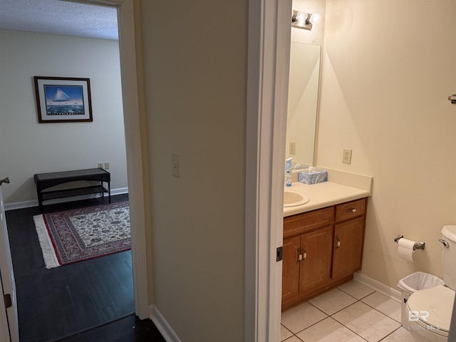 28712 Canal Rd, Orange Beach, AL 36561 - half bath featuring toilet, vanity, tile patterned floors, and baseboards