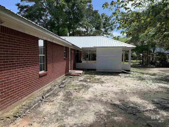 28712 Canal Rd, Orange Beach, AL 36561 - view of home's exterior featuring brick siding and metal roof