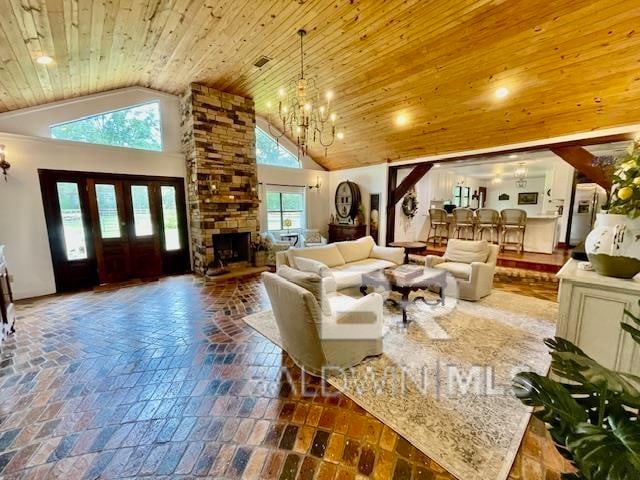 living room featuring wood ceiling, high vaulted ceiling, and plenty of natural light