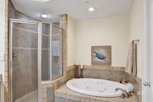 full bath featuring a shower stall, a whirlpool tub, and a textured ceiling