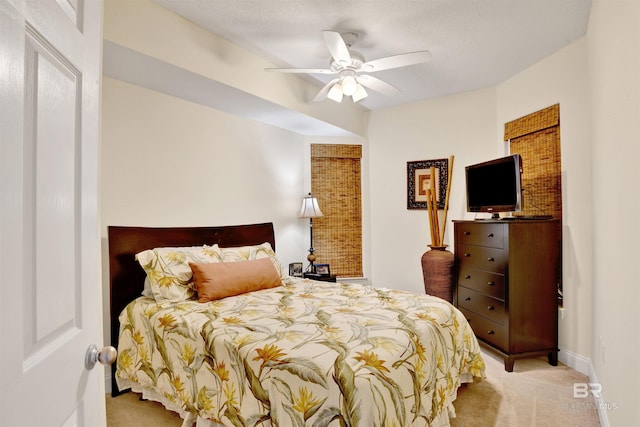 carpeted bedroom with baseboards and a ceiling fan