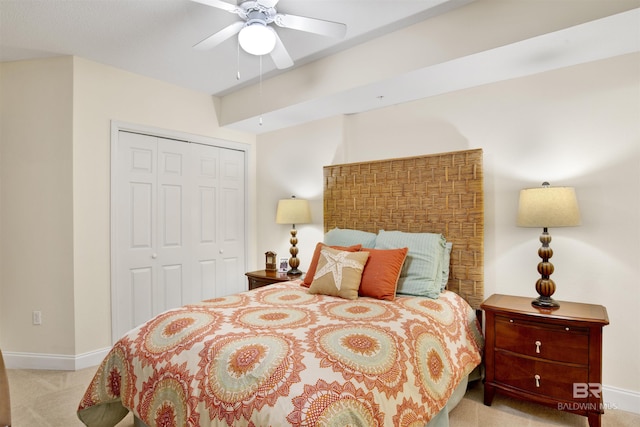bedroom with a ceiling fan, carpet, a closet, and baseboards