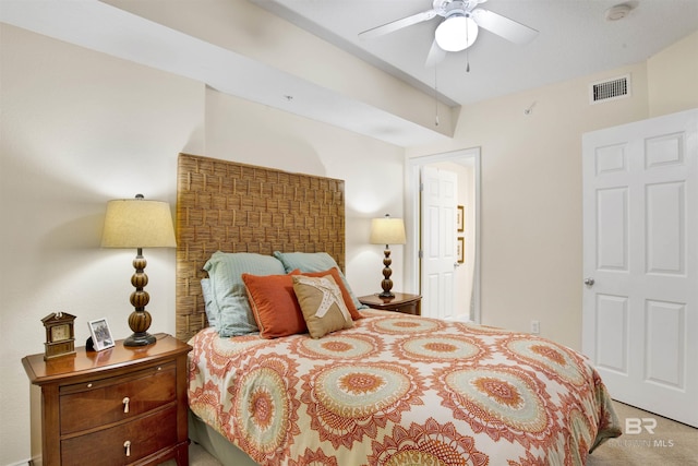 carpeted bedroom featuring a ceiling fan and visible vents