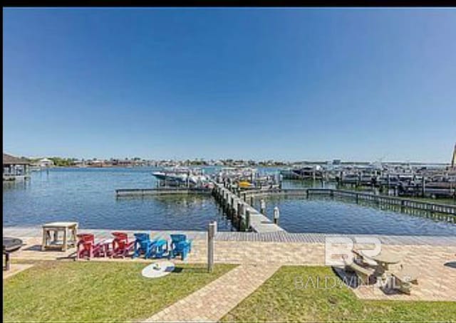 view of dock featuring a yard and a water view