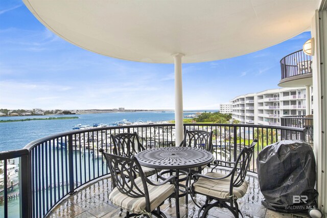 balcony with a water view and grilling area