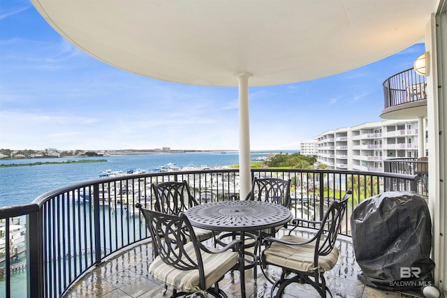 balcony featuring a water view and grilling area