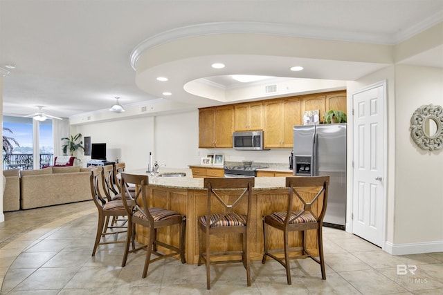 kitchen with ornamental molding, stainless steel appliances, recessed lighting, a sink, and light tile patterned floors