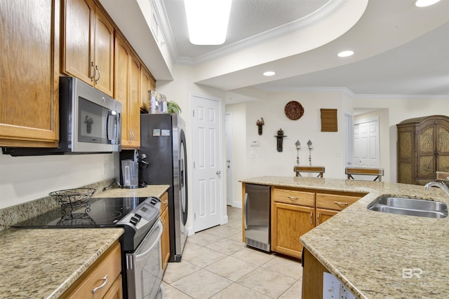 kitchen featuring ornamental molding, a sink, light tile patterned flooring, appliances with stainless steel finishes, and brown cabinetry