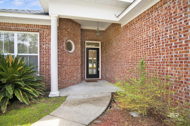 entrance to property with brick siding